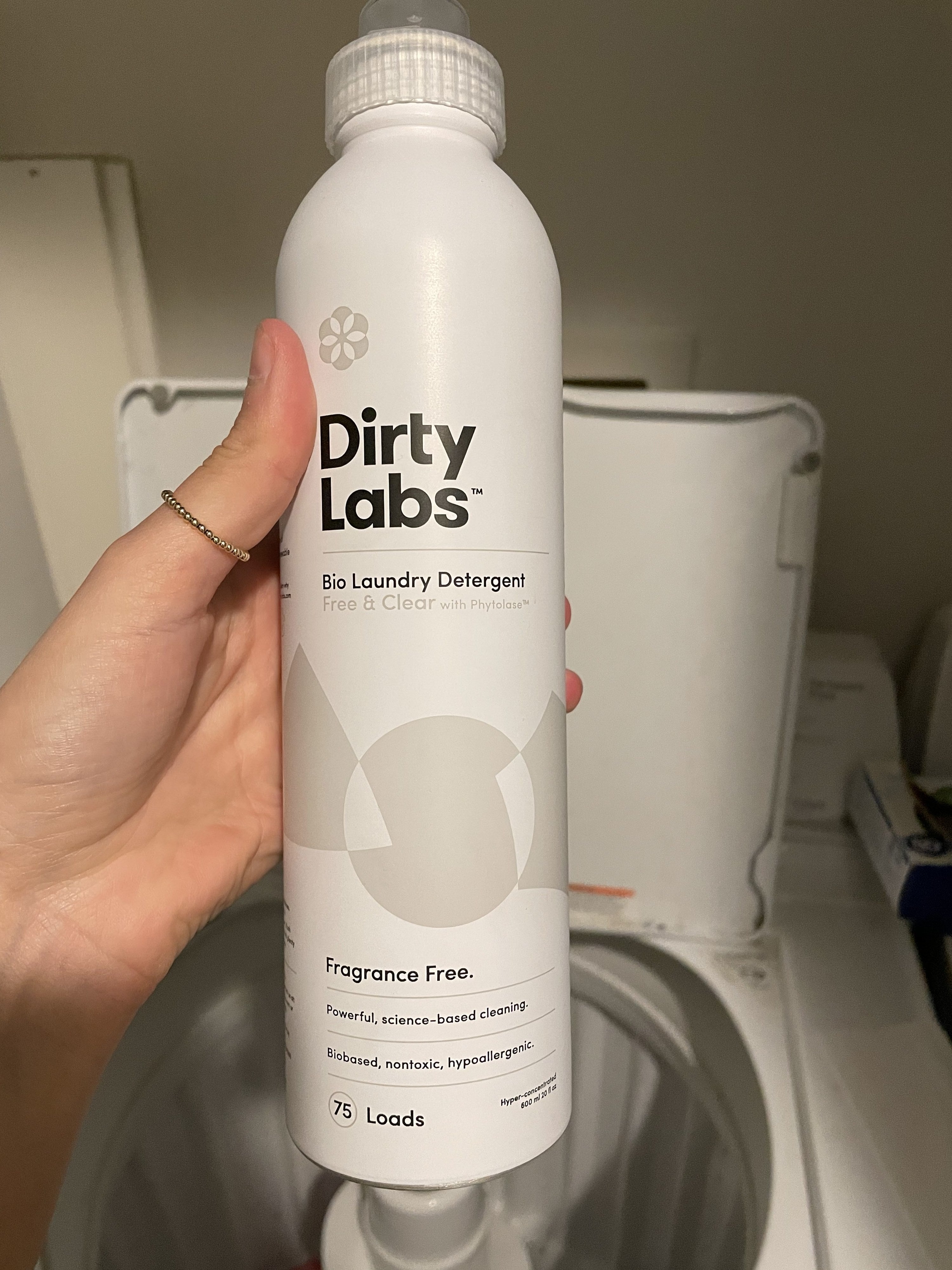 buzzfeed editor holding tall slender bottle of detergent