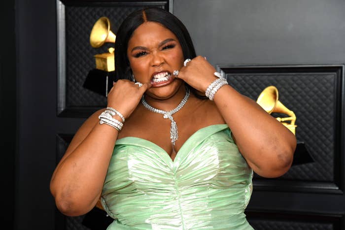 Lizzo showing off the grill in her mouth on the Grammys red carpet