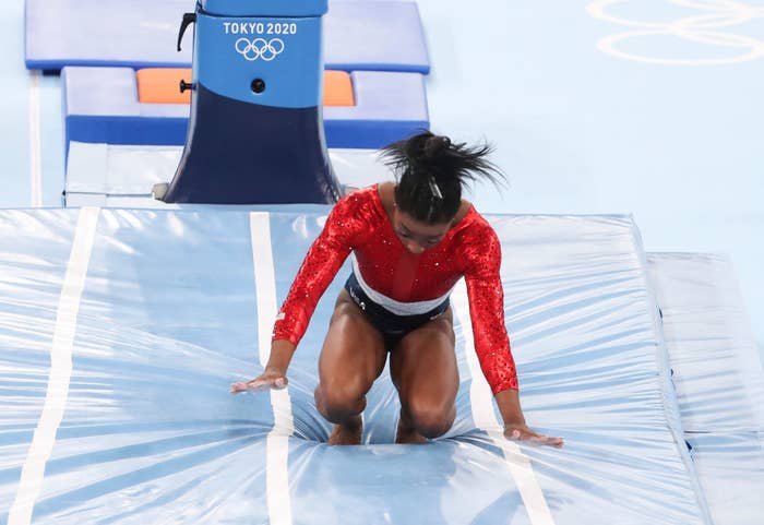 Biles landing her vault with her knees and hands almost touching the ground