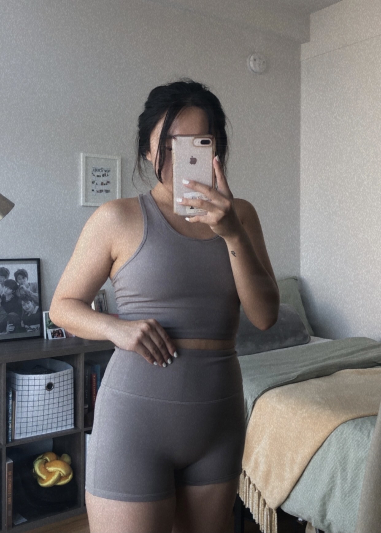 buzzfeed writer in a greyish-brown long-line sports bra and high-waisted shorts activewear set