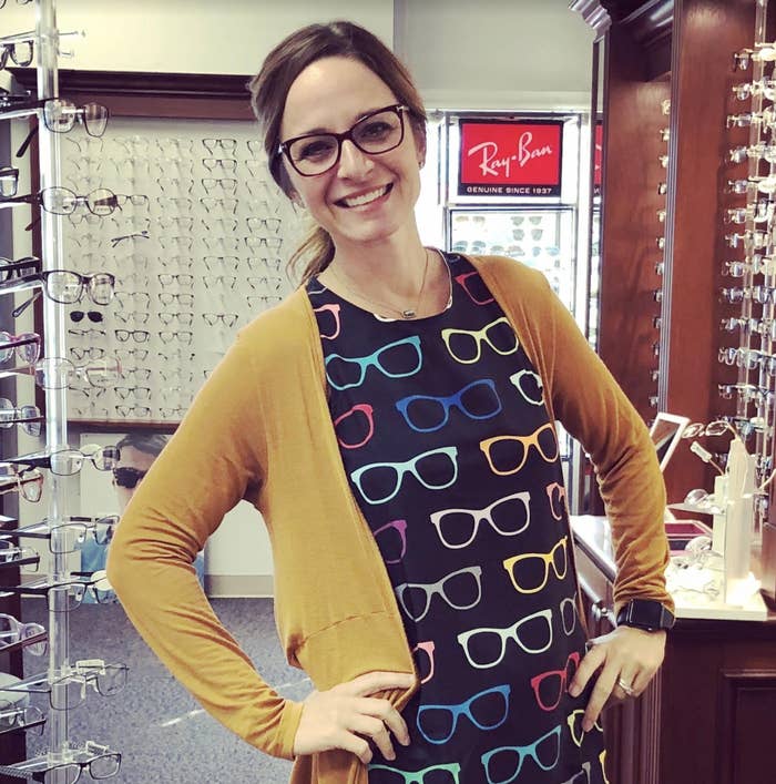 An image of the doctor posing in her office surrounded by glasses