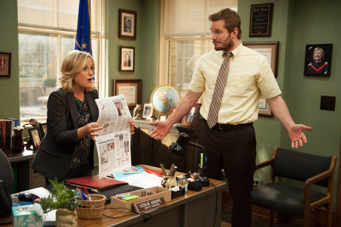 Andy standing next to Leslie&#x27;s desk in &quot;Parks and Rec&quot;