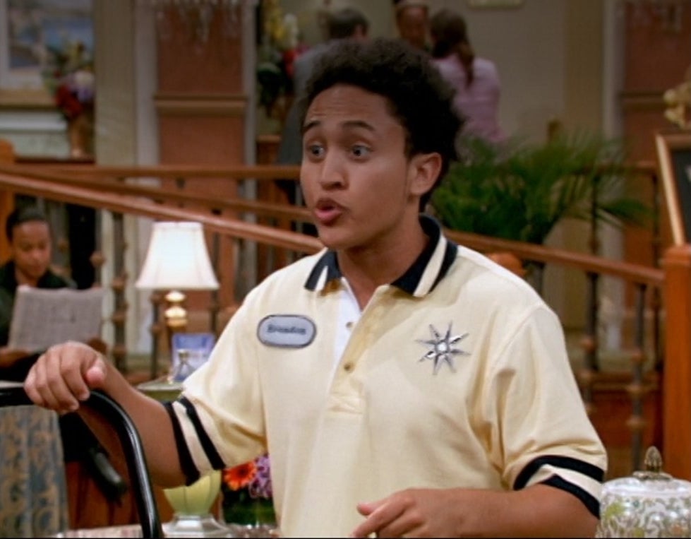 Tahj Mowry in a polo shirt in the Tipton lobby