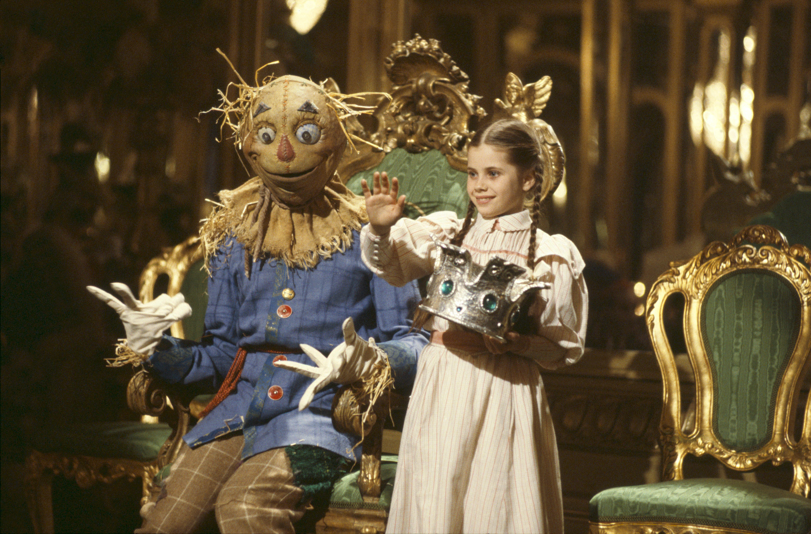 Dorothy and the scarecrow on a throne