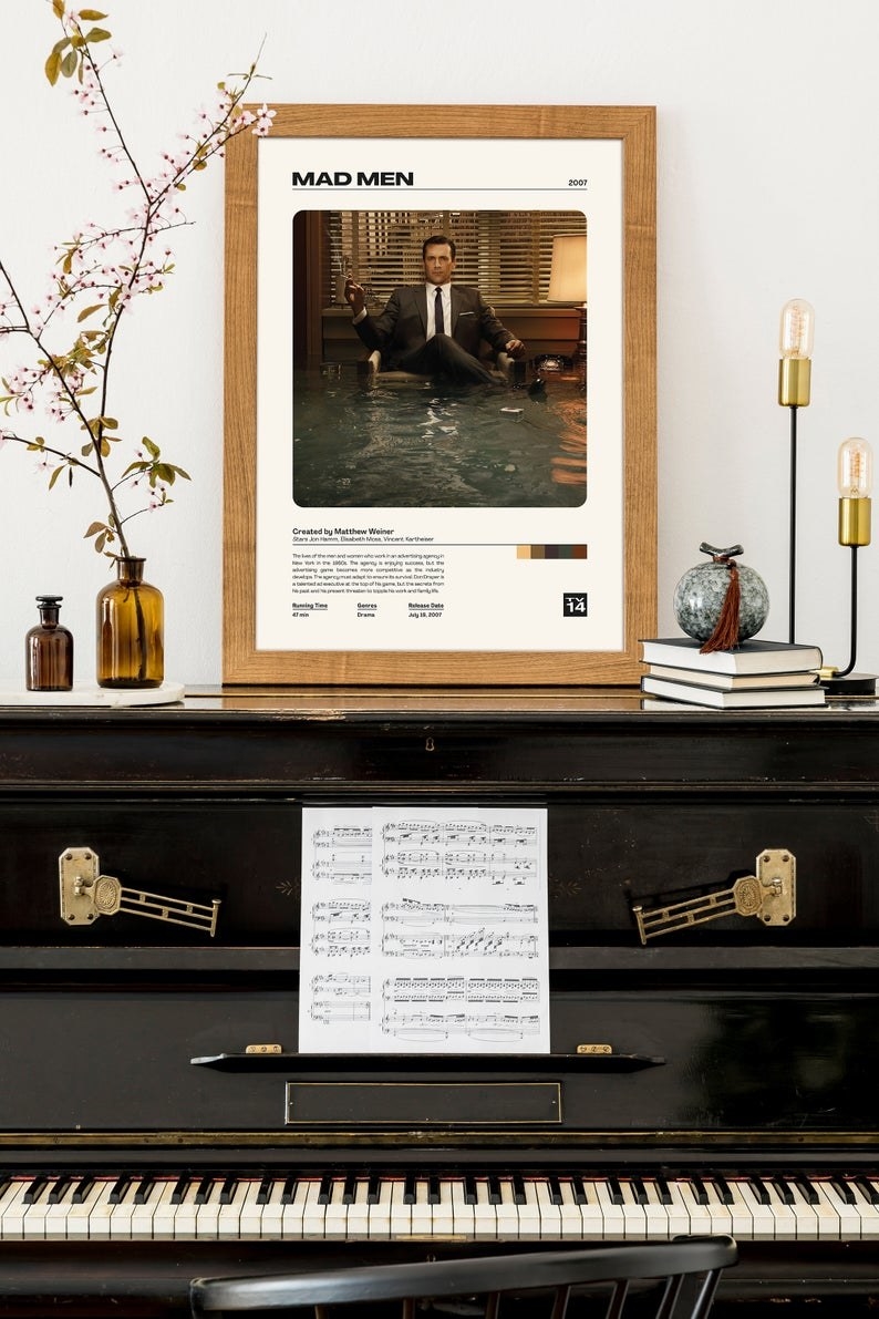 mad men framed print on top of piano