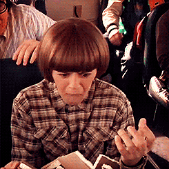 GIF of Coconut Head riding the bus and raising his fists