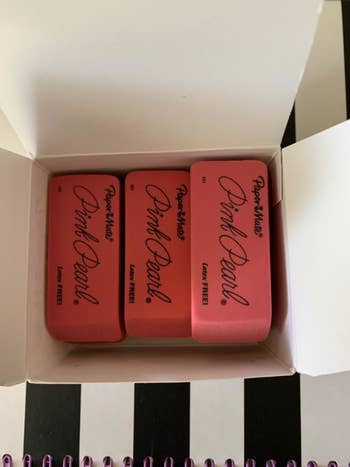 Reviewer's photo showing the pink erasers in a box