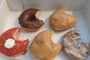 five donuts with a single bite taken out of each of them