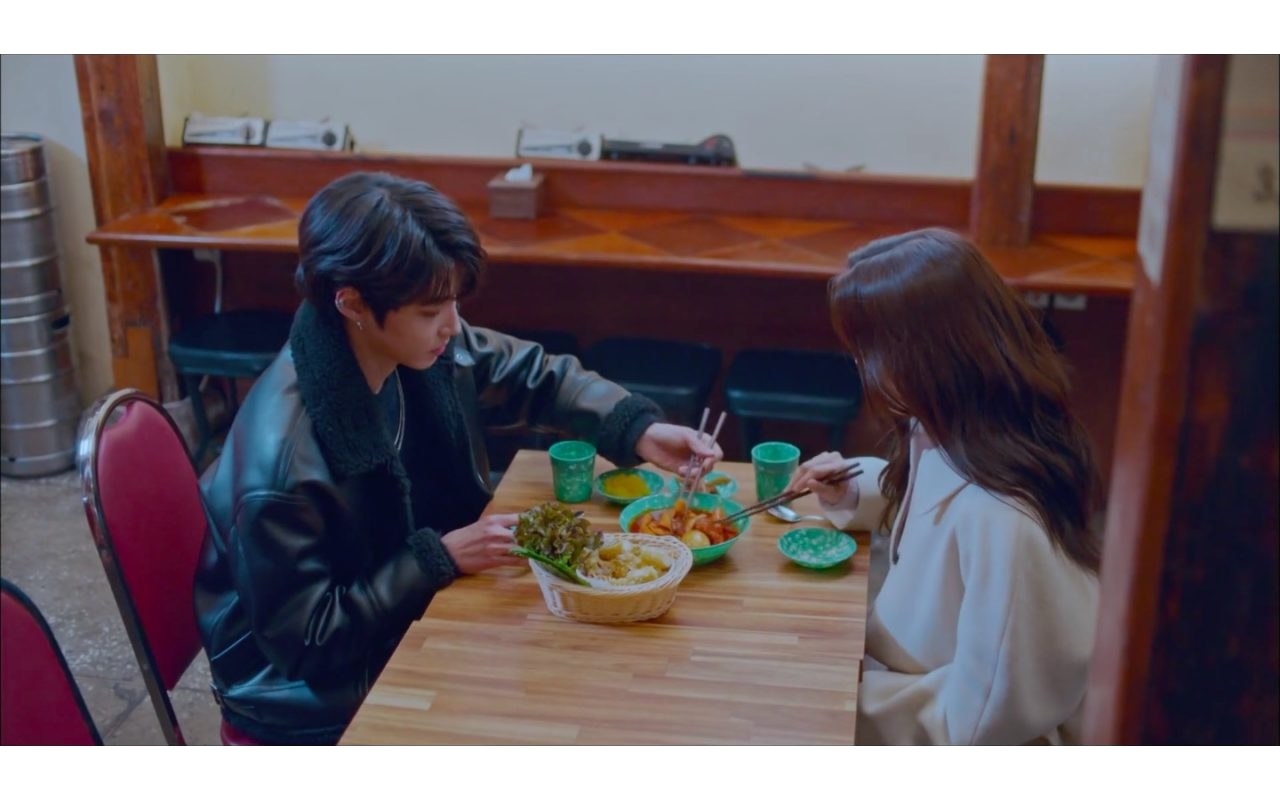 Man and woman eating at Korean restaurant