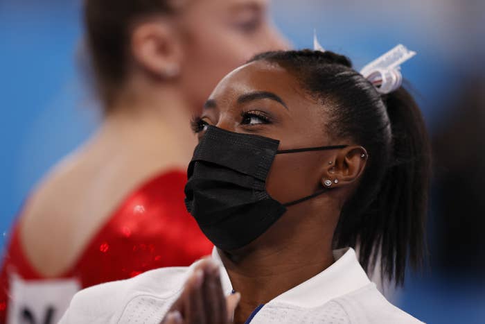 Simone Biles is shown wearing a face mask