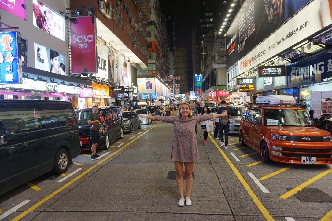 Woman standing in the middle of a busy street