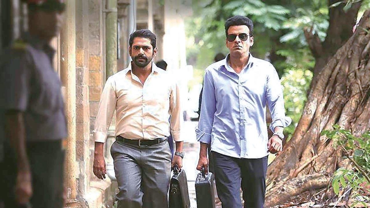 In a still from the family man, Jk talpade and srikant walk with briefcases