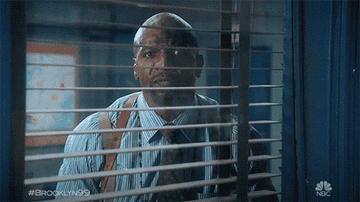 Terry Crews looking through his window and then shutting the blinds