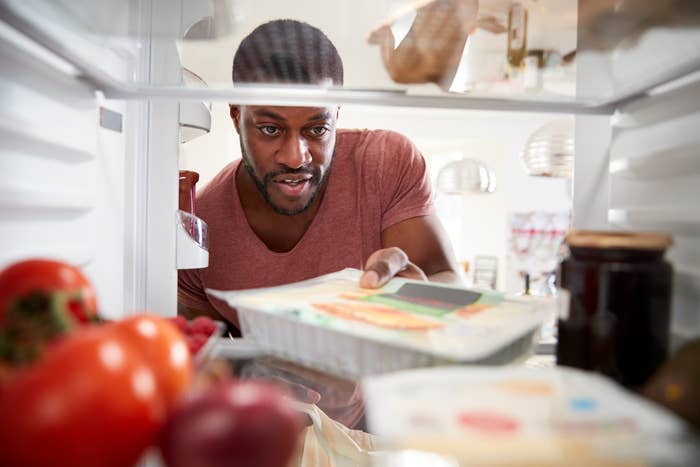 man looking into fridge