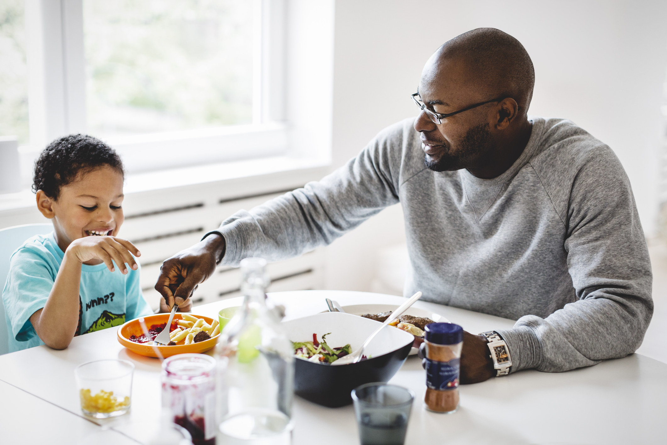 man feeding his son