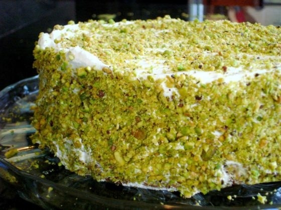 Large pistachio-coated and frosted cake