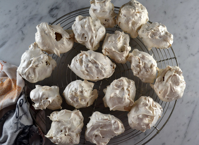 Cooling tray crowded with meringue Brutti ma Buoni cookies