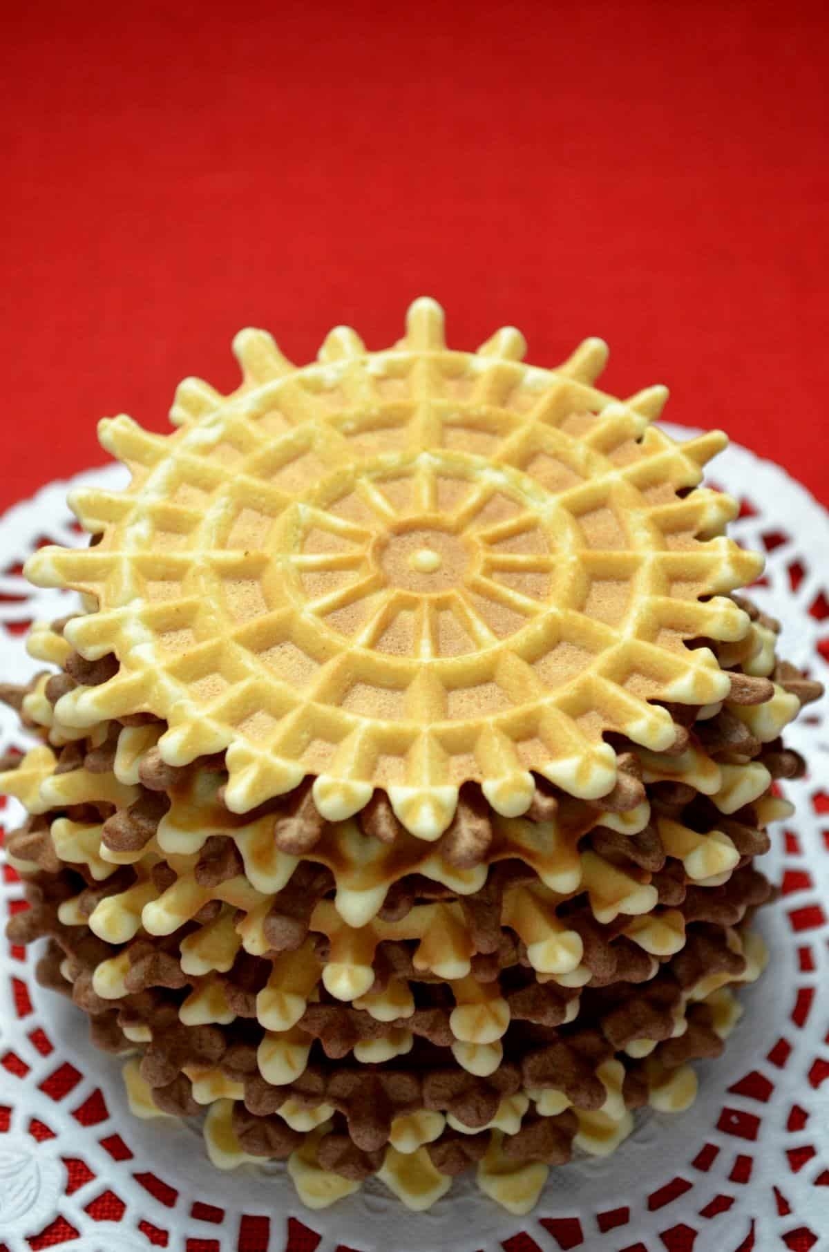 A tall stack of symmetric pizzelle waffles