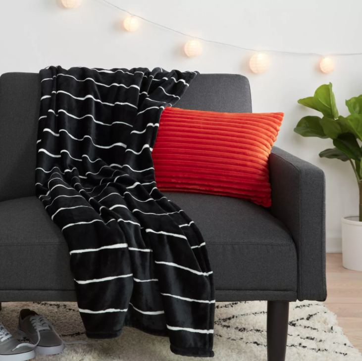 Black and white striped throw blanket draped over a couch
