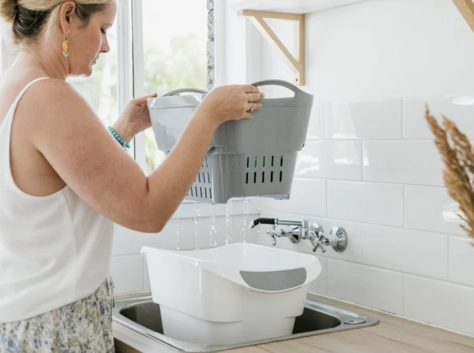 a model lifts the hand washing strainer out of the bucket