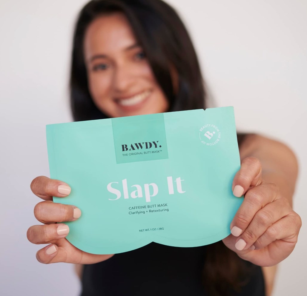 the butt mask in blue packaging being held by a model