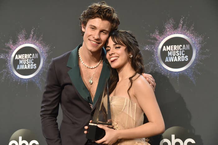 Shawn and Camilla posing at the American Music Awards while Camilla hold her trophy