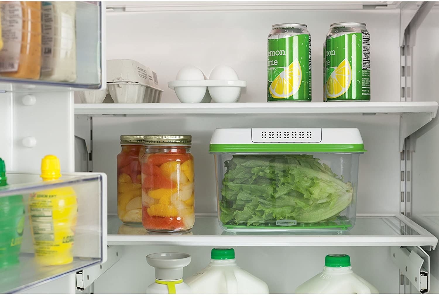 The produce saving box inside a fridge; it is filled with fresh lettuce