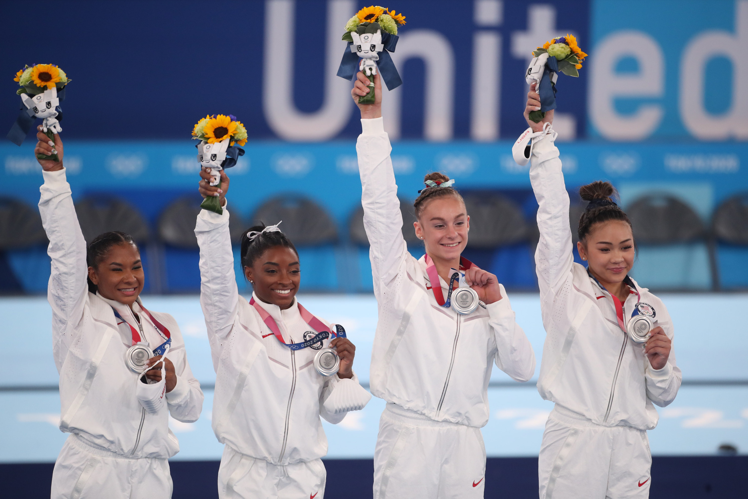 The U.S. Women&#x27;s Gymnastics team saluting the crowd and posing with their medals