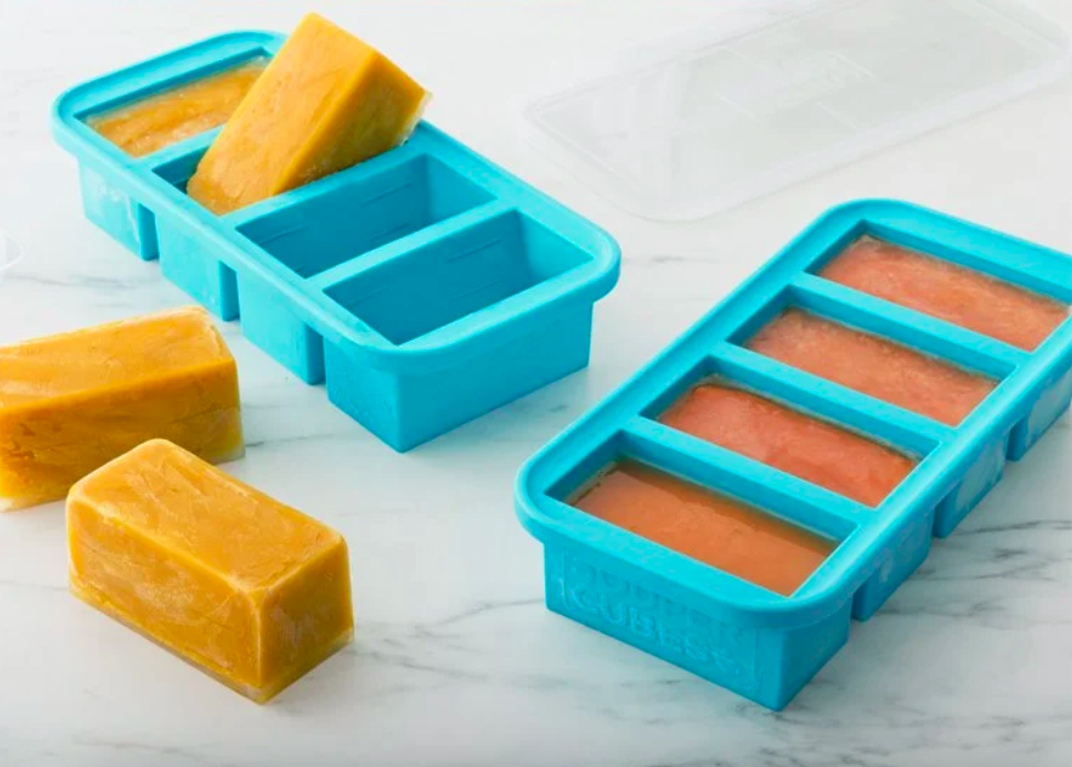 A Soup and Stock Silicone Freezer Tray filled with fresh soup and one filled with frozen soup cubes