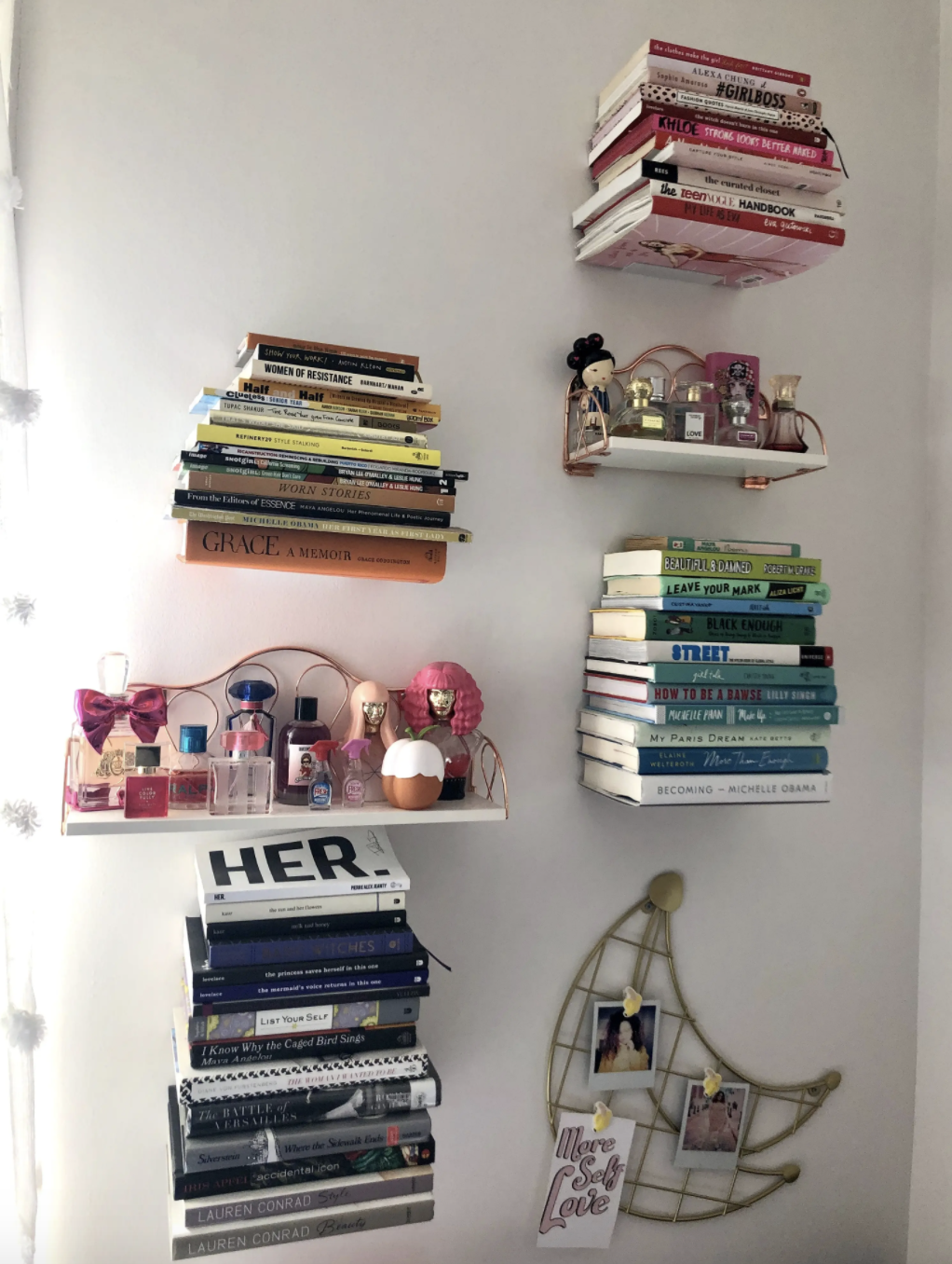 A postulation  of books are displayed connected  a wall