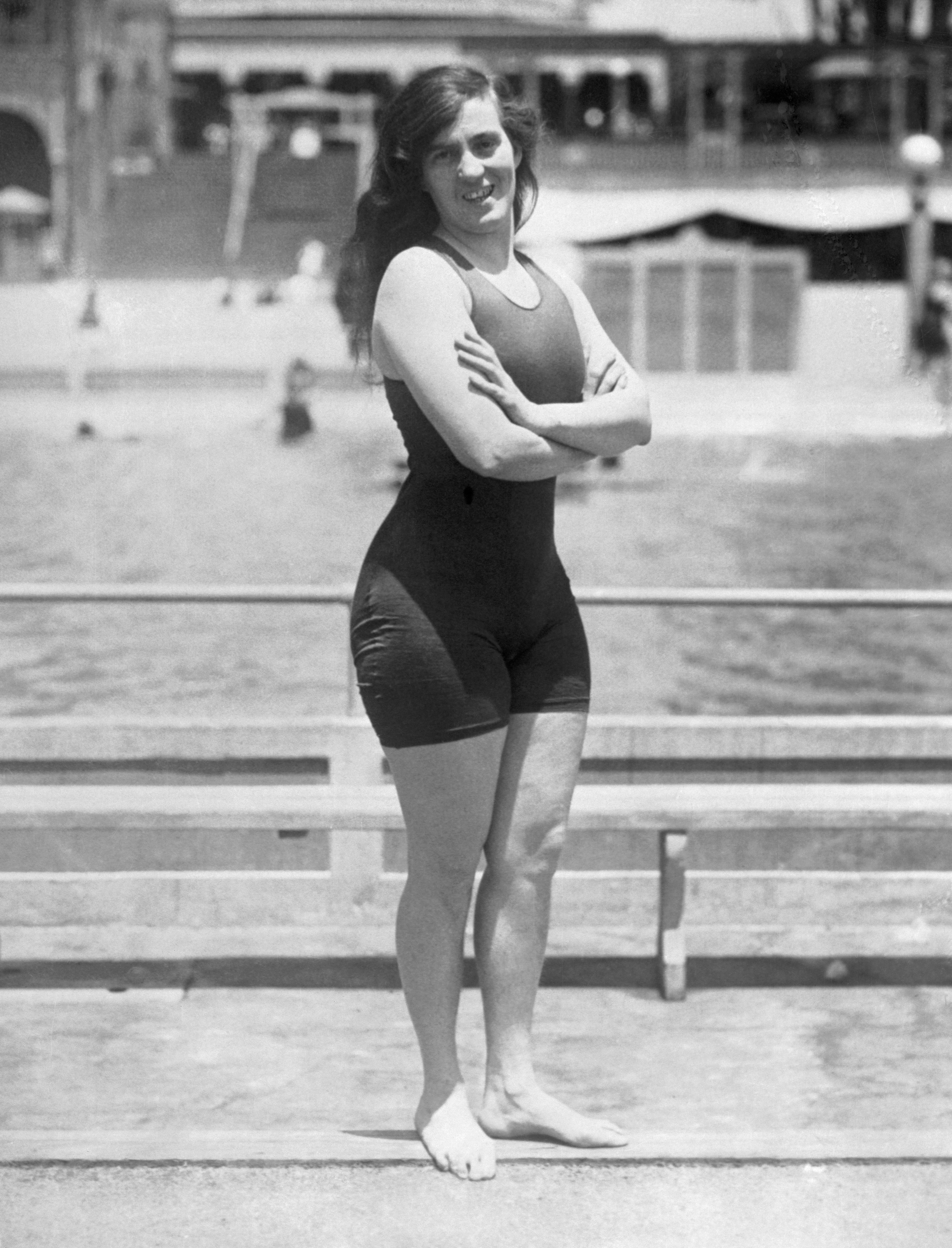 Fanny Durack wearing a swimsuit posing for a photo with her arms crossed