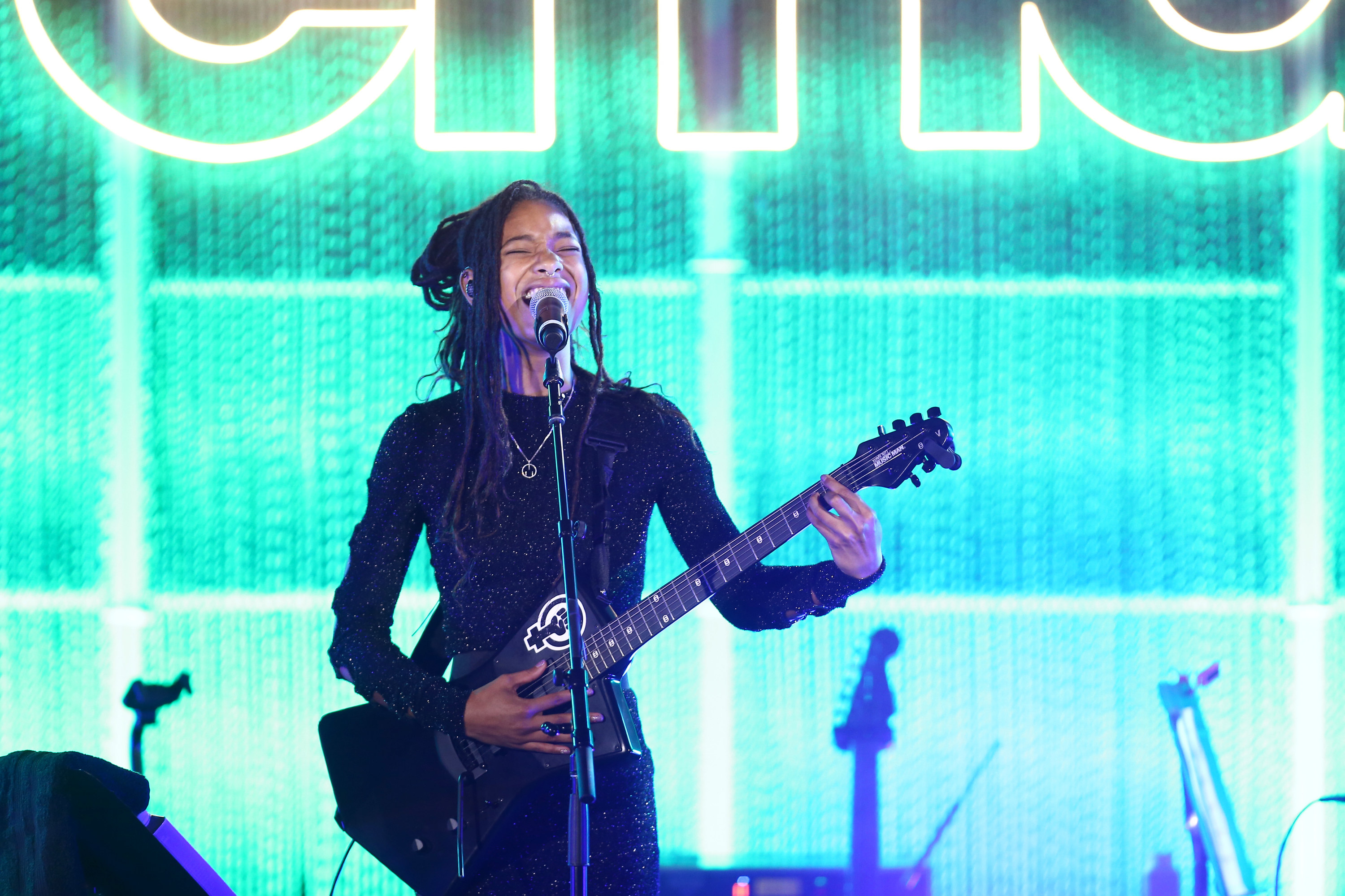 Willow Smith performs onstage with a guitar