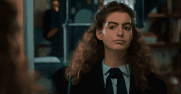 Anne Hathaway raising her eyebrow in The Princess Diaries
