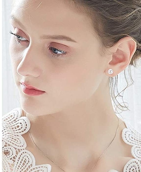 model wearing a faux pearl earring on their ear