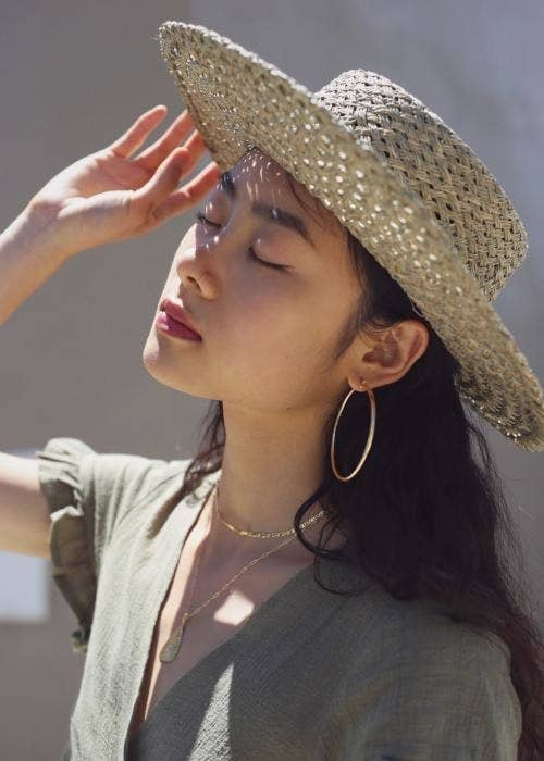 model wearing large gold hoops on their ears