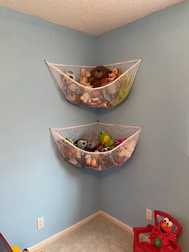 Reviewer's white hammocks holding stuffed animals and hanging on a blue wall