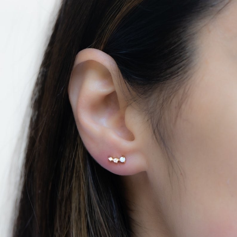 the opal studs on an ear