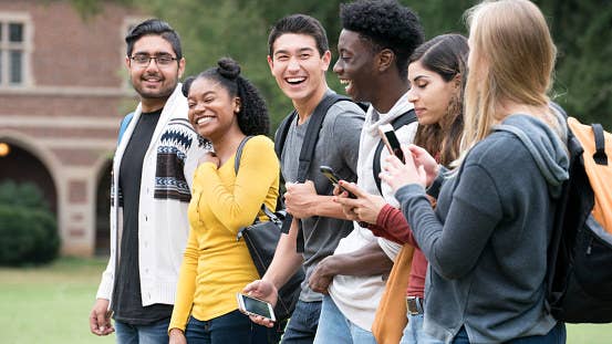 College students smiling and walking to class