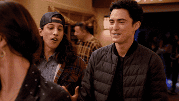 Paxton smiling and walking past Devi in the hallway as she smiles back in &quot;Never Have I Ever&quot;