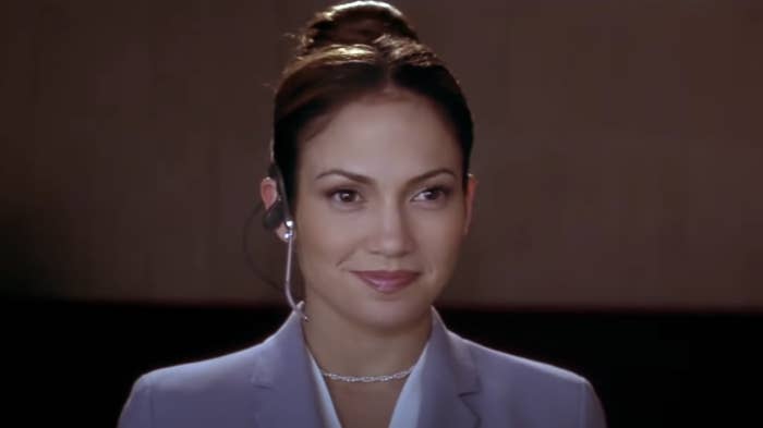 Jennifer Lopez smiles while wearing a headset as Mary