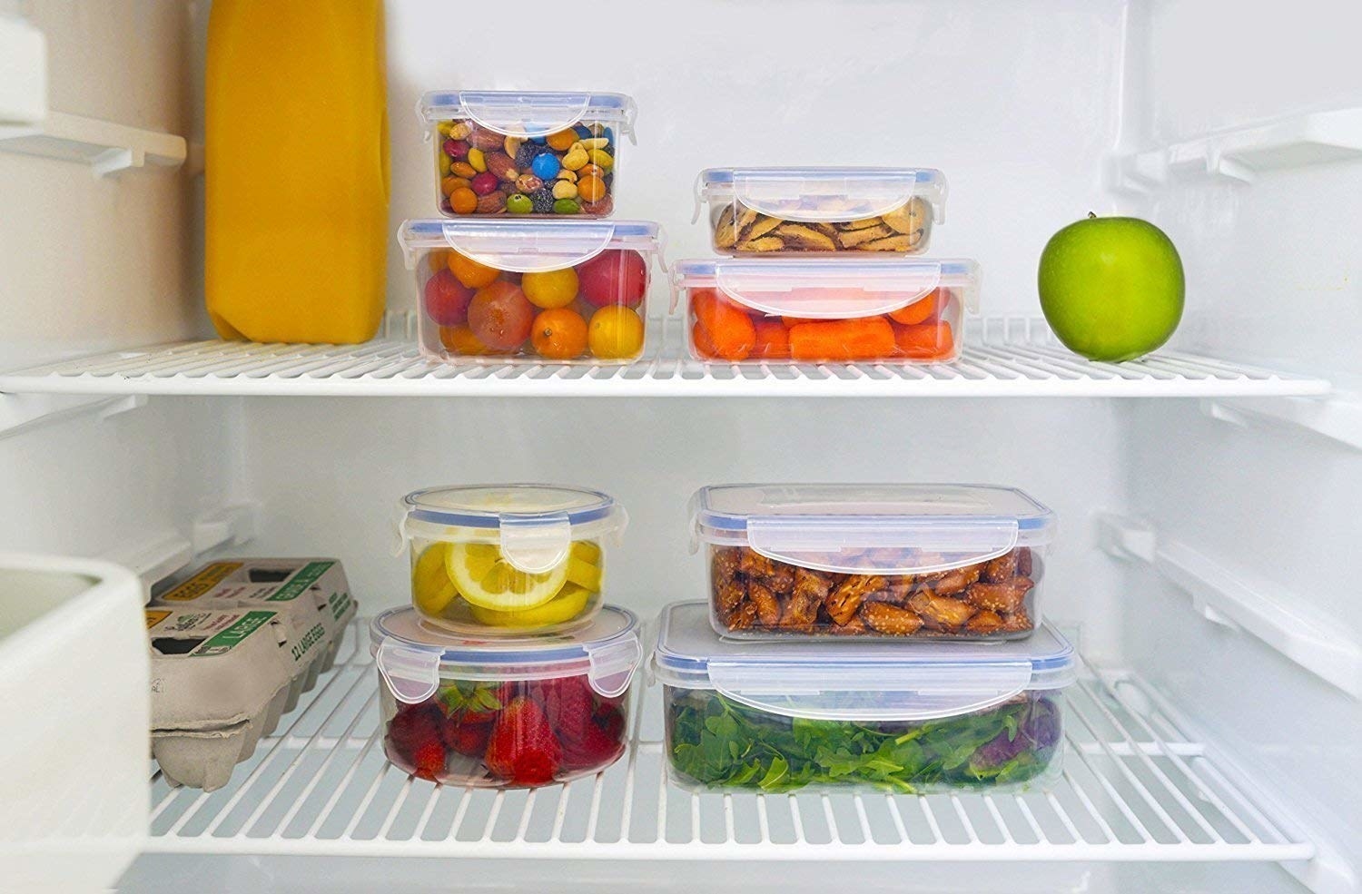 6 airtight containers in fridge containing fruits, vegetables, dry fruits and candy