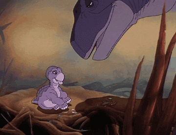 Little Foot licks his mother&#x27;s face in The Land Before Time