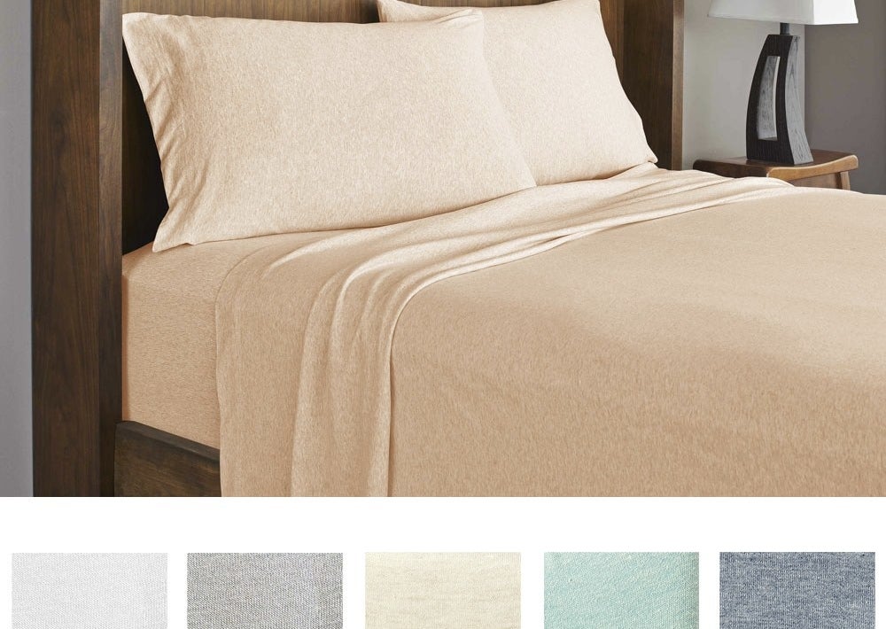 The blush sheet set on a queen size bed