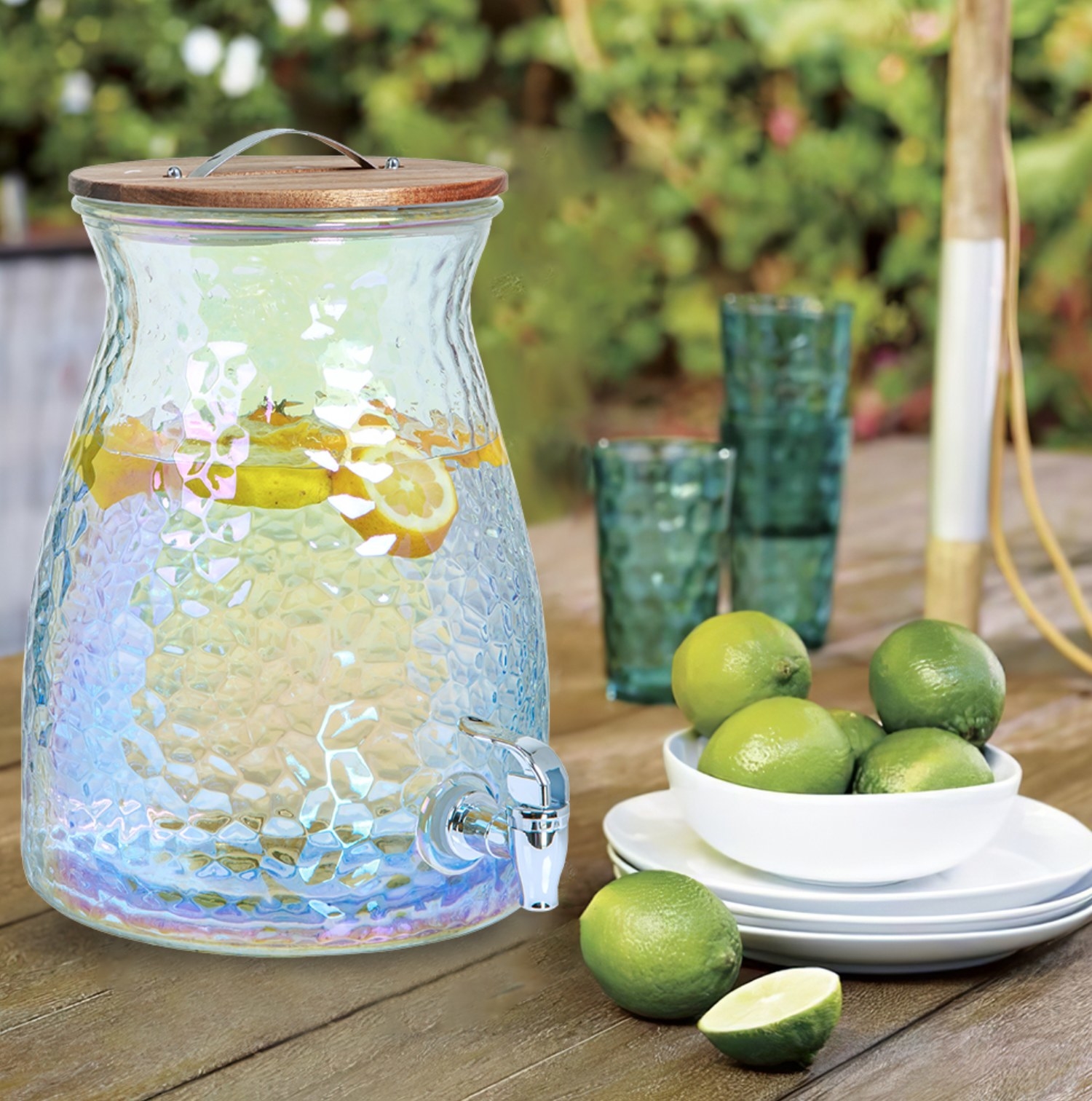 the beverage dispenser with water and lemons in it next to a bowl of limes