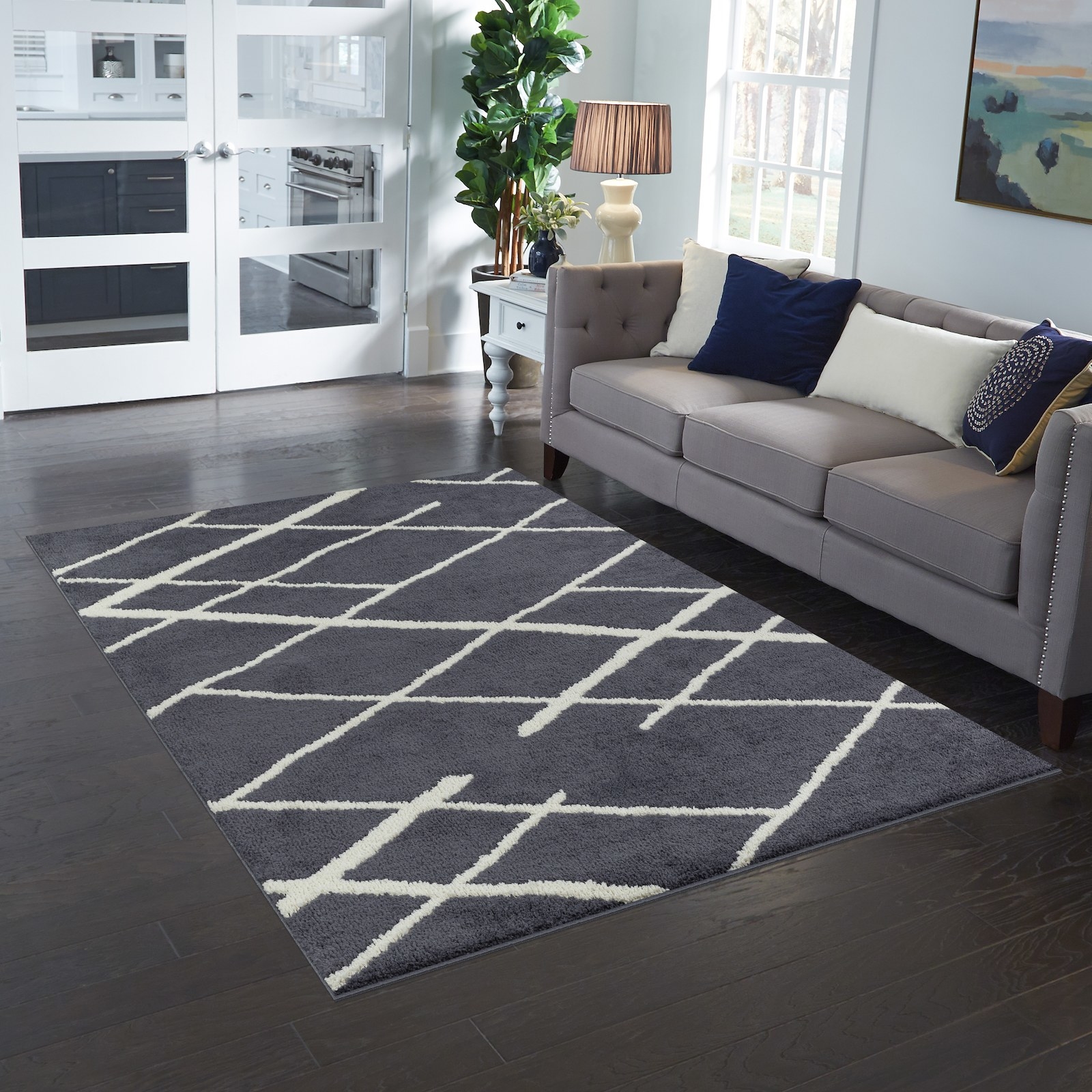 The gray and cream rug with a diamond pattern in a living room