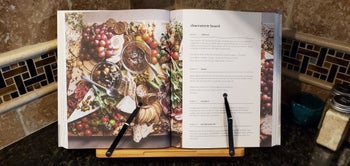 reviewer photo of the a cookbook in the cookbook holder