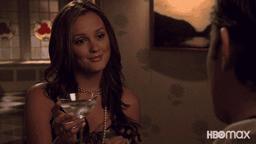 Blair Waldorf toasts a full martini glass with someone else&#x27;s