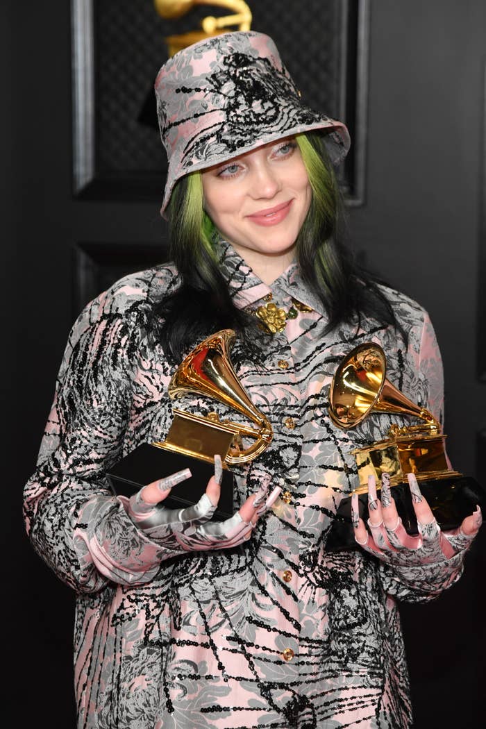 Billie holding two of her Grammy Awards