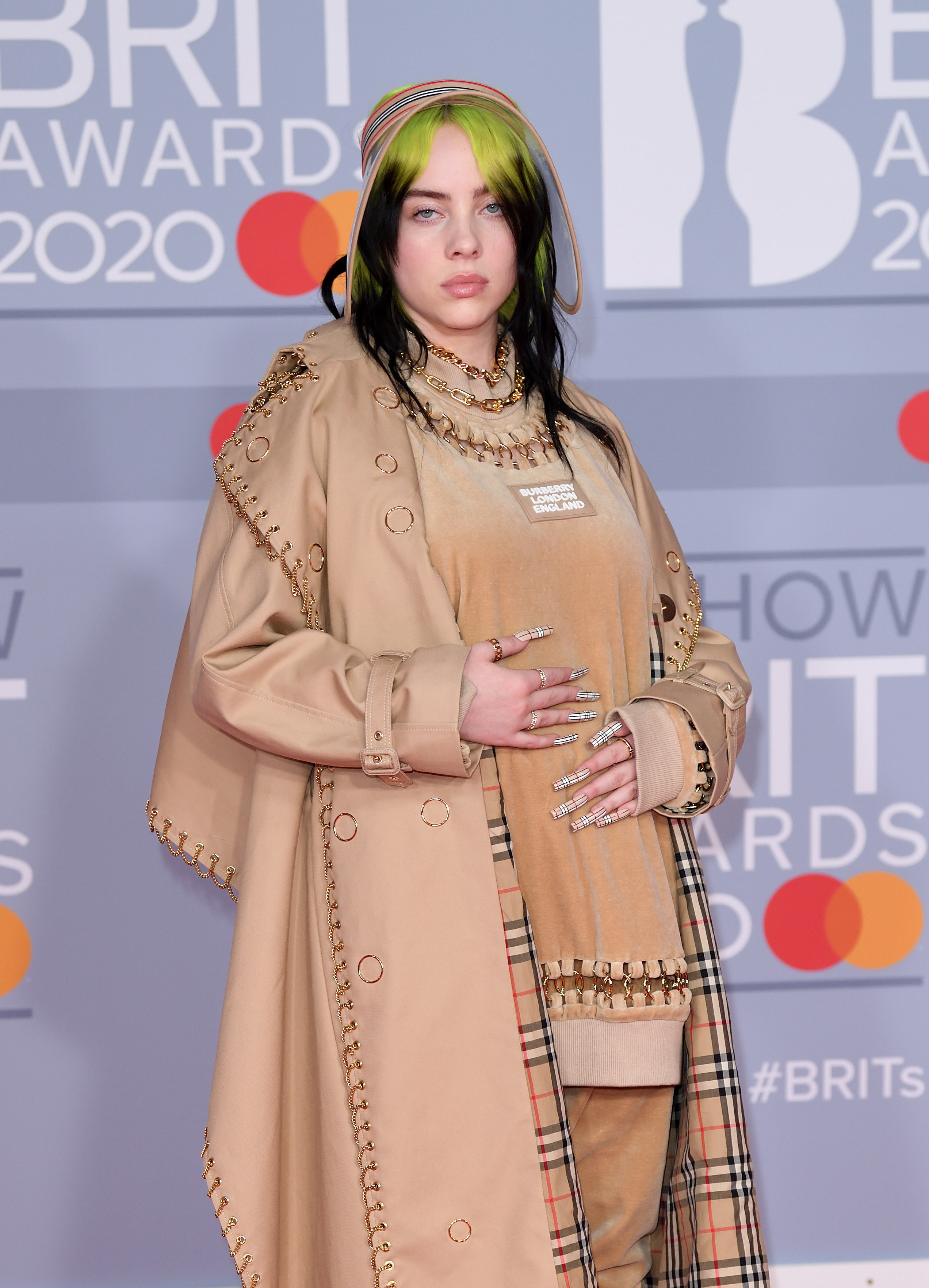 Billie on the red carpet in a loose trench coat