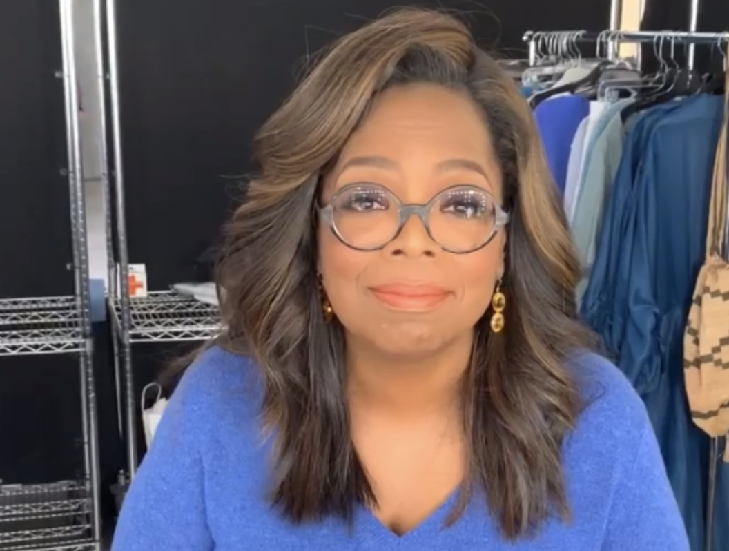 Oprah looking amused and wearing glasses